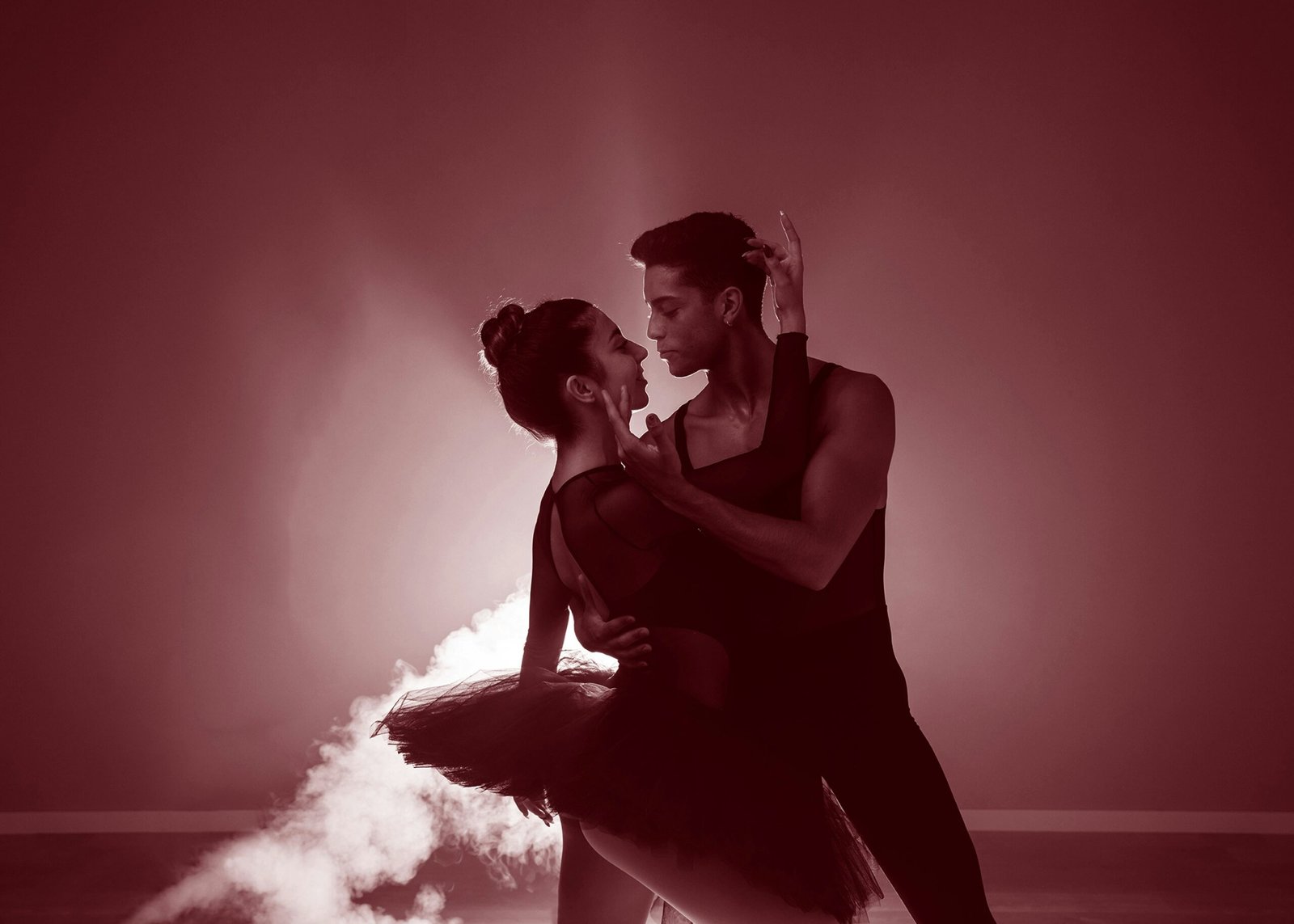 A man and a woman dance on a cloud of smoke